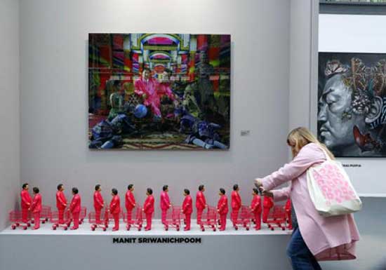 Manit Sriwanichapoom's 'Pink Man' pushed his shopping trolley at last month's Paris Art Fair. AFP Photo